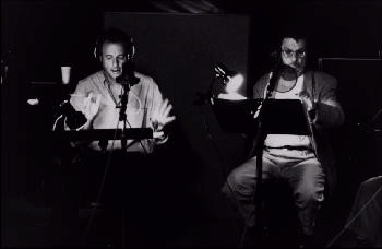 John and Leonard recording: WIDTH=350 HEIGTH=228><BR>
<H3>John de Lancie and Leonard Nimoy in a recording session</H3>
<h5>Alien Voices®, Inc.  All Rights Reserved</h5><BR>
<h3>As an actor, de Lancie scored a triumph as Cassius in the BBC production of

