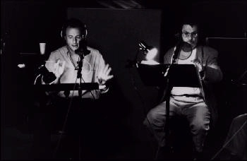 John and Leonard recording: WIDTH=350 HEIGTH=228><BR>
<H3>John de Lancie and Leonard Nimoy in a recording session</H3>
<h5>Alien Voices®, Inc.  All Rights Reserved</h5><BR>
<h3>As an actor, de Lancie scored a triumph as Cassius in the BBC production of
